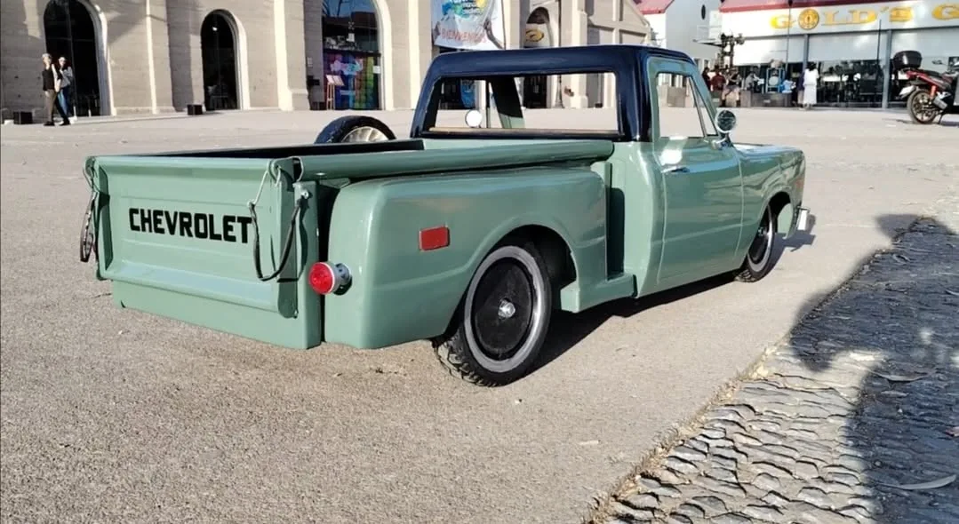 Olive green Chevy C10 stepside with side-mount spare wheel