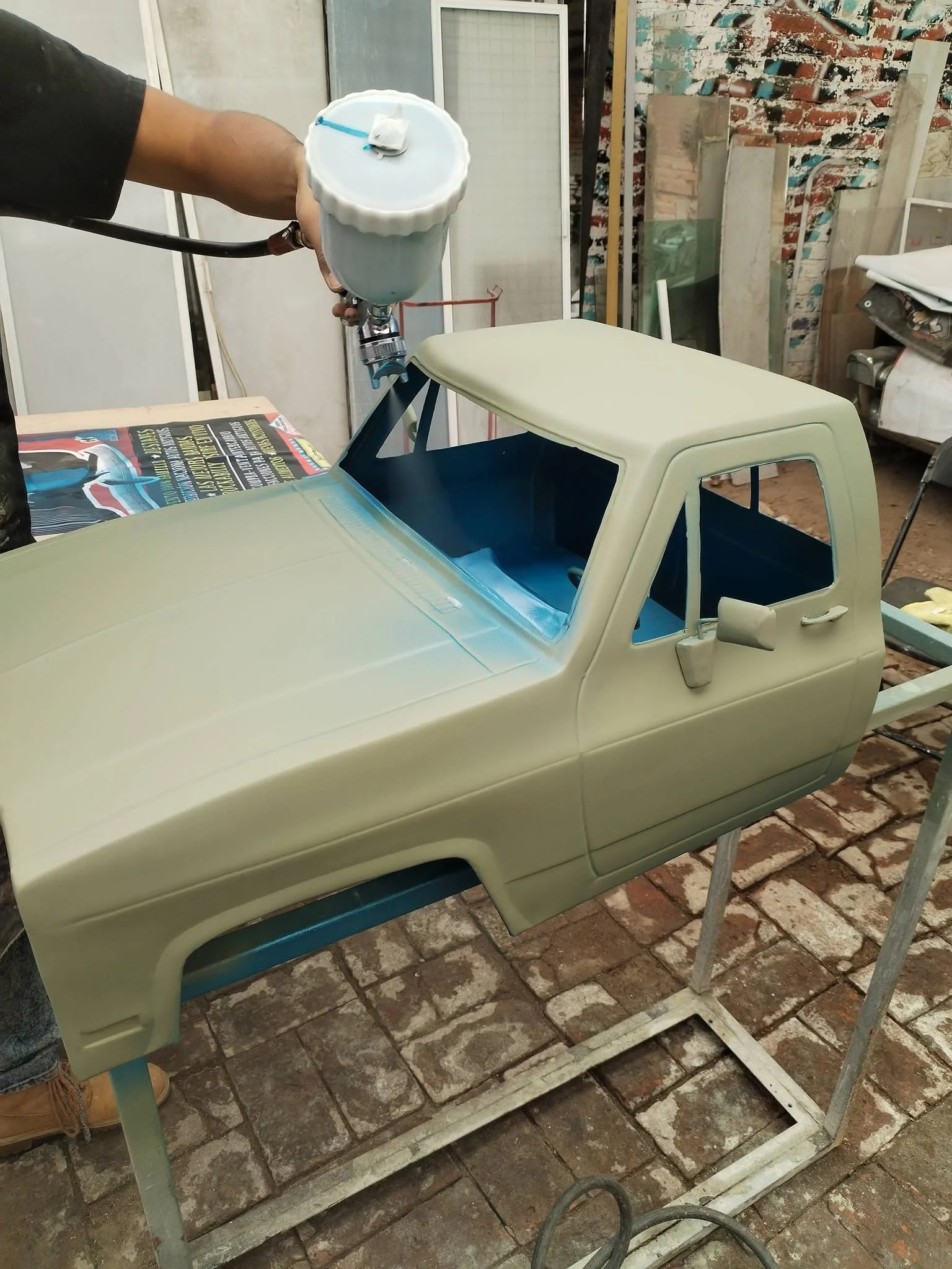 Lowrider Customs master artisan spraying custom paint with HVLP gun